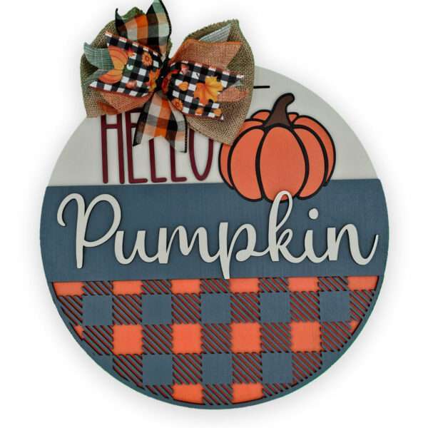 A custom door sign featuring the text "Hello Pumpkin" in white cursive on a blue and orange checkered background. An orange pumpkin illustration sits at the top, while a bow with mixed burlap, orange, black, and white plaid patterns adds charm at the top.