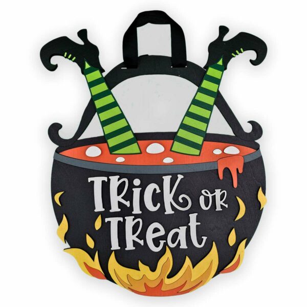 A Halloween decoration featuring a black cauldron with green and black striped witch legs sticking out of the top. The words "Trick or Treat" are written on the cauldron, which is surrounded by yellow and orange flames at the bottom, adding to its spooky charm.