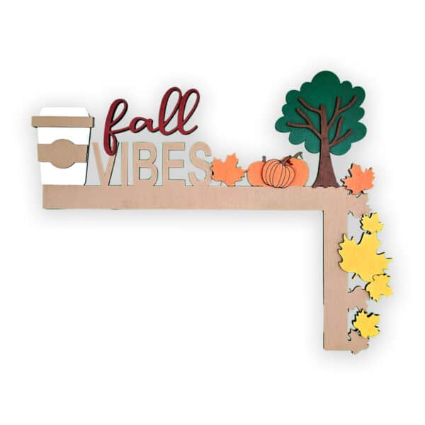 A decorative wooden frame perfect for your door corner, featuring the words "fall VIBES" along with a coffee cup, pumpkin, tree, and colorful autumn leaves.